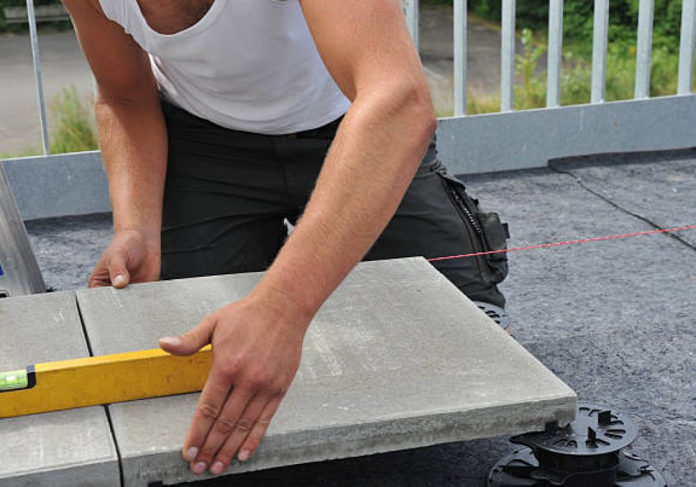 A craftsman is laying terrace boards
